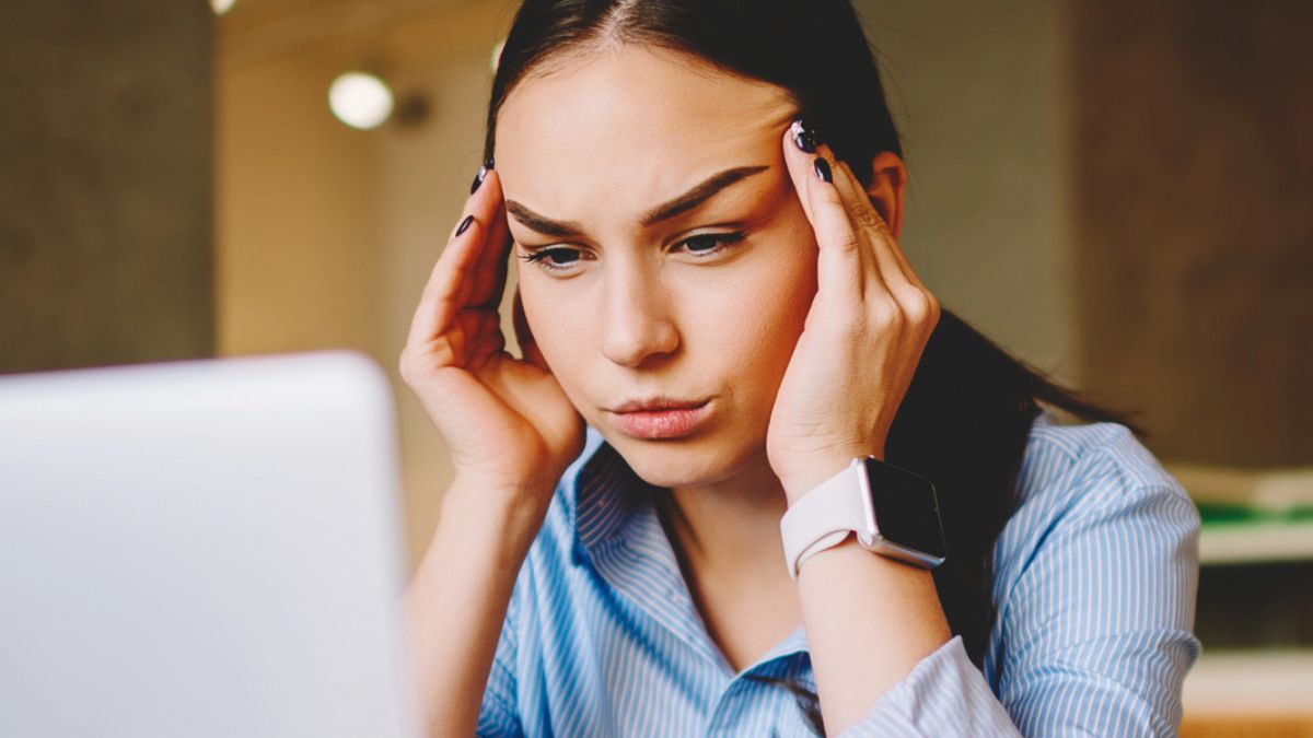 woman sitting on her hands stressed