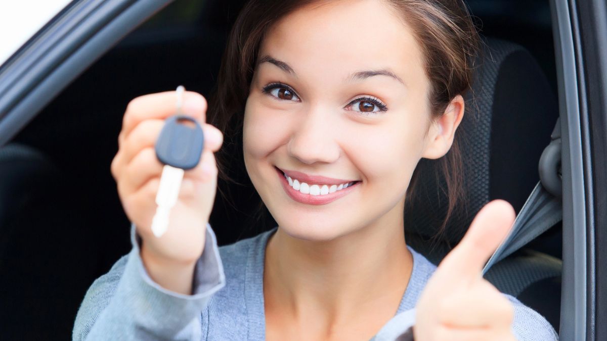 woman smiling with key car