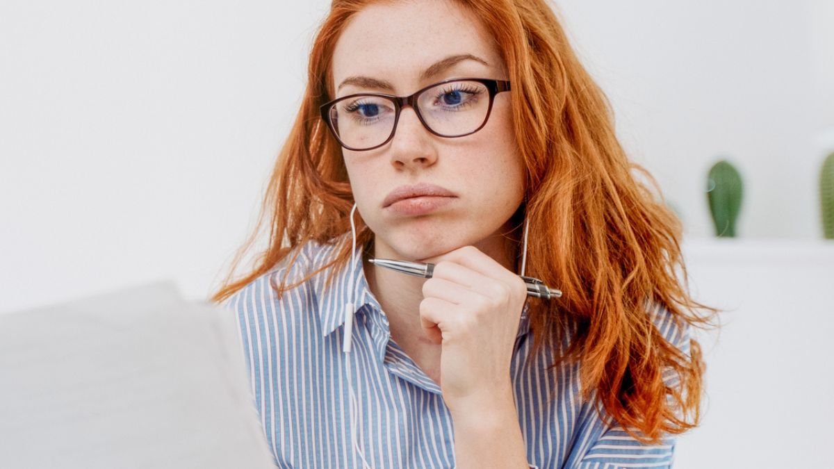 woman staring at documents
