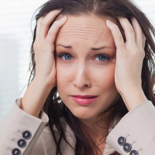 woman worried hands on head stressed