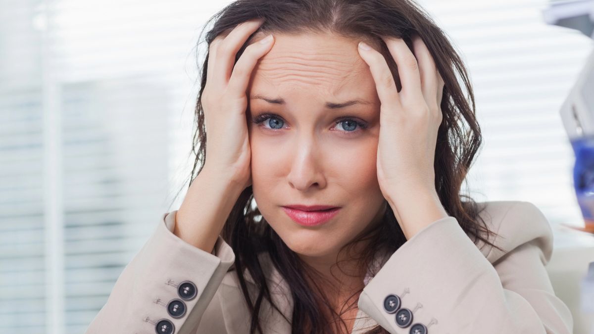 woman worried hands on head stressed